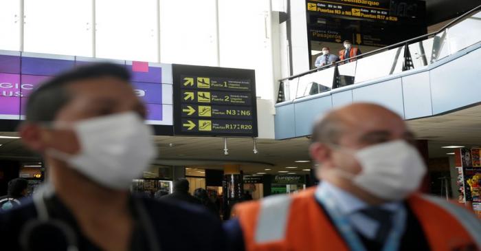 FILE PHOTO:  El Alto Airport workers wearing protective masks are seen following the outbreak