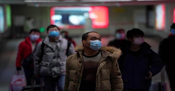 FILE PHOTO:  People wearing masks are seen at a subway station in Shanghai