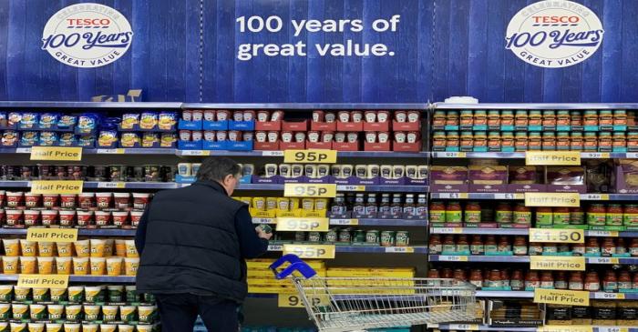 FILE PHOTO: A man looks at products on a shelf inside Tesco Extra superstore near Manchester