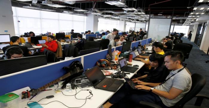 FILE PHOTO: Employees of Traveloka are seen working at the company's headquarters in Jakarta