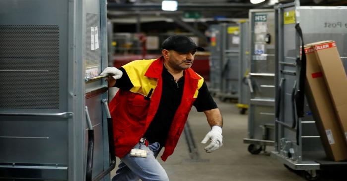 An employee works at a distribution centre of German postal and logistics group Deutsche Post