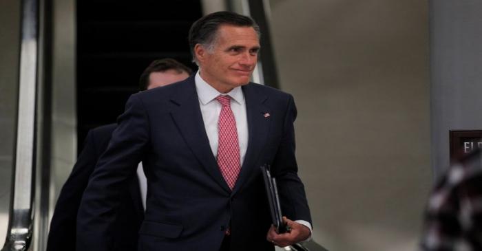 Senator Mitt Romney exits at the end of the day as the Trump impeachment trial continues in