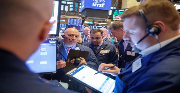 Traders work on the floor of the New York Stock Exchange shortly after the opening bell in New