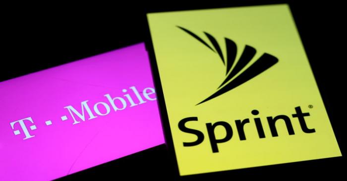 FILE PHOTO: Smartphones with the logos of T-Mobile and Sprint are seen in this illustration