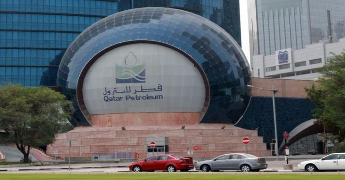 FILE PHOTO: Cars are parked outside the headquartes of Qatar Petroleum in Doha