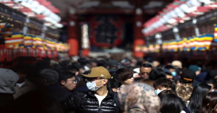 A man wearing a protective face mask is seen at the Senso-ji Temple in Asakusa district in