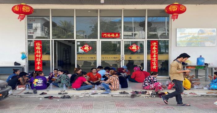 Cambodian workers eat lunch outside a Chinese-operated factory in Sihanoukville Special