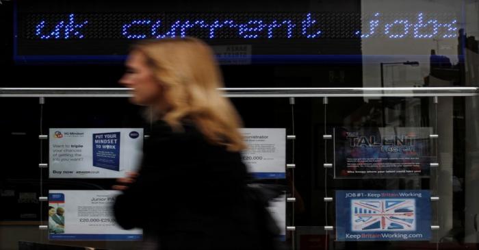 A pedestrian walks past an employment centre in London