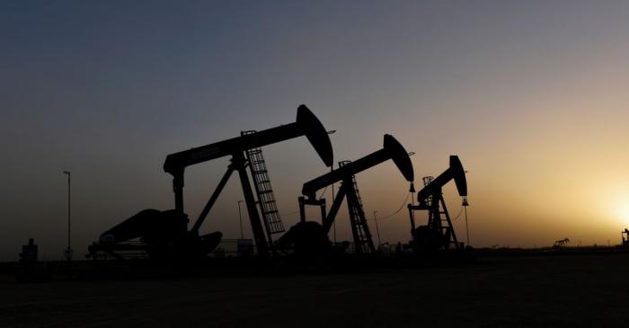 FILE PHOTO: Pump jacks operate at sunset in Midland