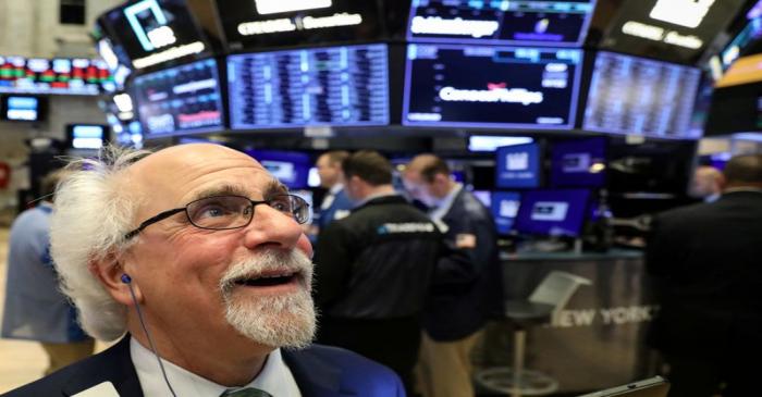 FILE PHOTO: Traders work on the floor at the NYSE in New York