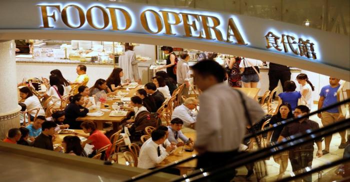 People eat at a food court in Singapore