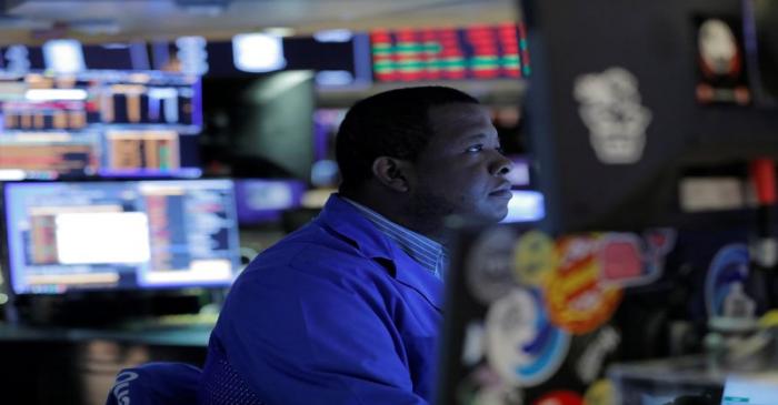 A trader works on the trading floor after the closing bell at the New York Stock Exchange
