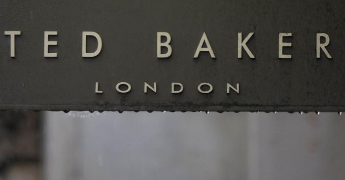 Rain drips off a sign on a Ted Baker sign on a store in London, Britain