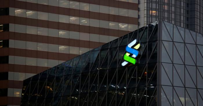 FILE PHOTO: A logo of Standard Chartered is displayed at the financial Central district in Hong