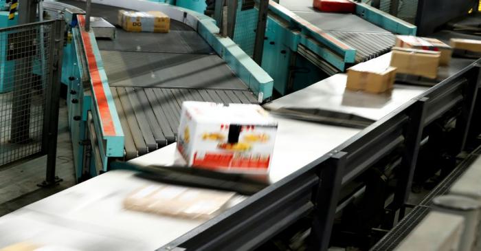 Parcels are seen on a conveyor belt at a distribution centre of German postal and logistics