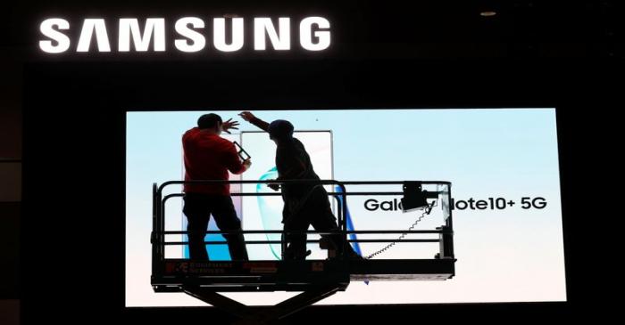 Workers set up a Samsung display in the lobby of the Las Vegas Convention Center in preparation