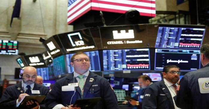 Traders work on the floor of the New York Stock Exchange shortly after the opening bell in New