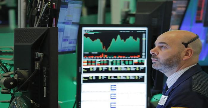 A trader works on the floor of the New York Stock Exchange shortly before the closing bell in