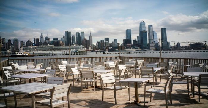 Empty chairs are seen at the deck of a local restaurant that is closed due to the outbreak of