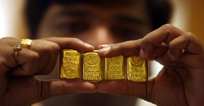 A salesman displays gold bars inside jewellery shop on the occasion of Akshaya Tritiya festival