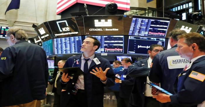 Traders work on the floor of the New York Stock Exchange shortly after the opening bell in New