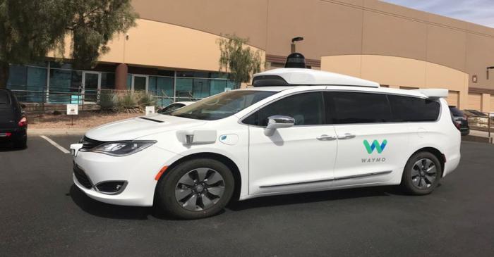 FILE PHOTO: A Waymo self-driving vehicle is parked outside the Alphabet company's offices where