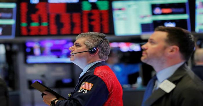 FILE PHOTO: Traders work on the floor of the New York Stock Exchange shortly after the opening