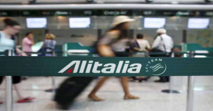 FILE PHOTO: People walk in the Alitalia departure hall during a strike by Italy's national