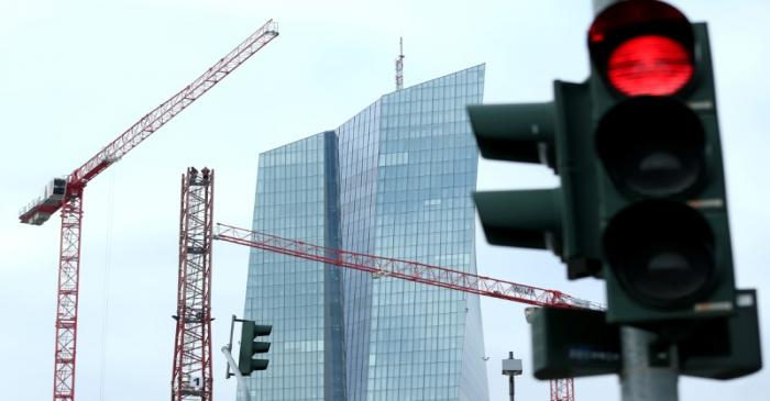 FILE PHOTO: Specialists work on a crane in front of the European Central Bank (ECB) in