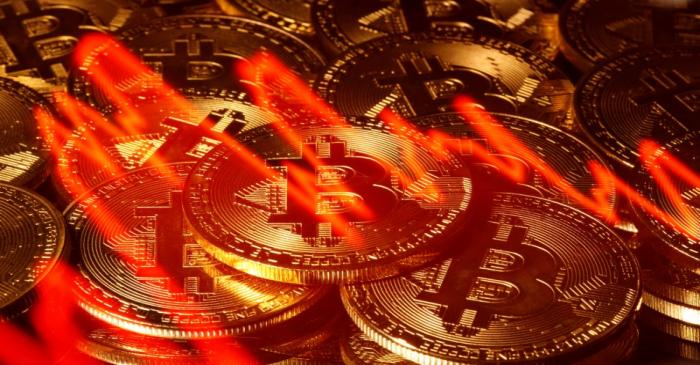 Illumination of the stock graph is seen on the representations of virtual currency Bitcoin in