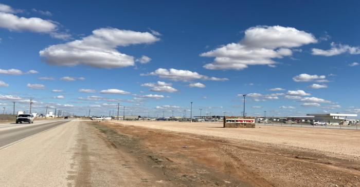 A car drives past signage for ProPetro office space in Midland