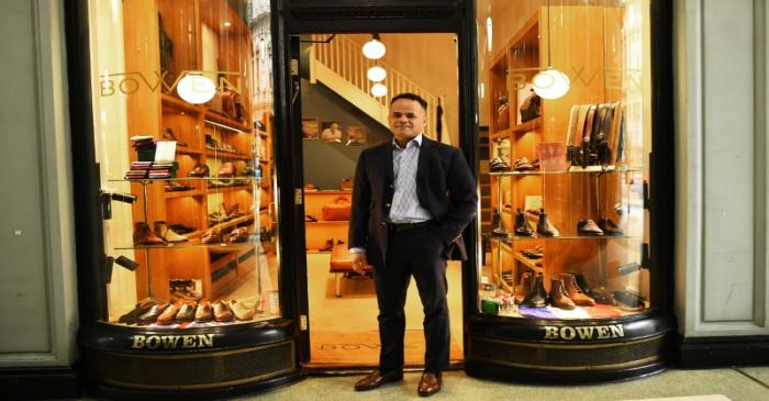 Horles Ramirez, Manager of Bowen, poses outside his store in London
