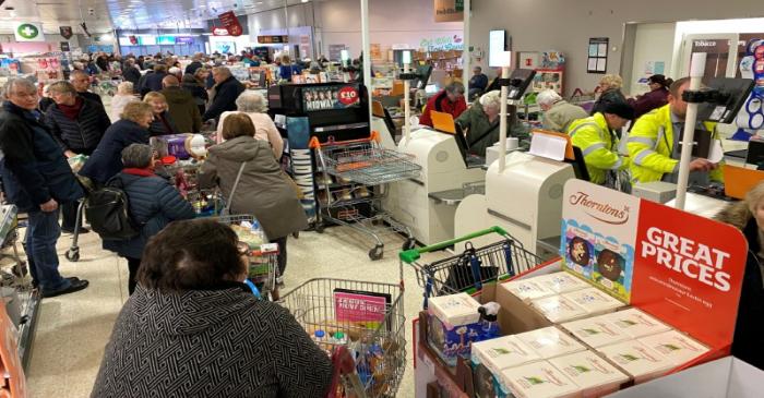 FILE PHOTO: Shoppers inside a Sainsburys supermarket in Watford