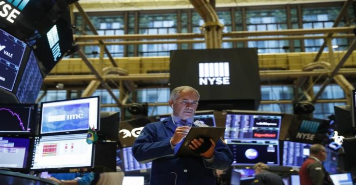 Traders work on the floor of the NYSE in New York