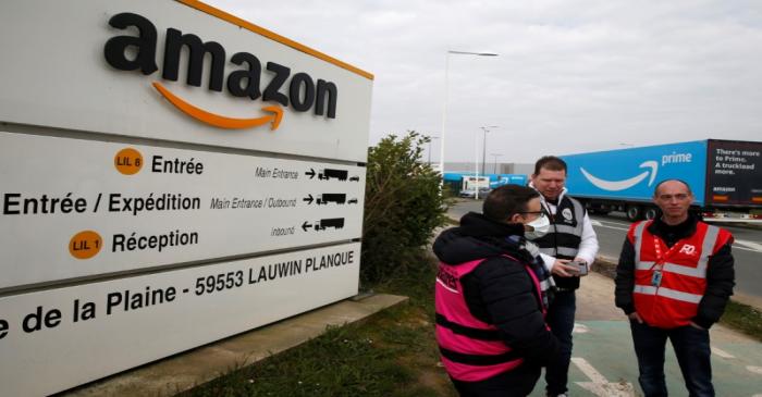 Amazon employees on strike gather outside the Amazon logistics center in Lauwin-Planque