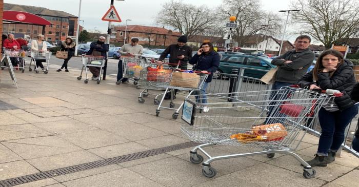 Shoppers line up to enter a Sainsbury?s supermarket amid the coronavirus outbreak in Manchester