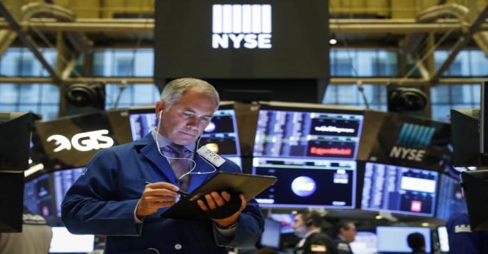 Traders work on the floor of the NYSE in New York