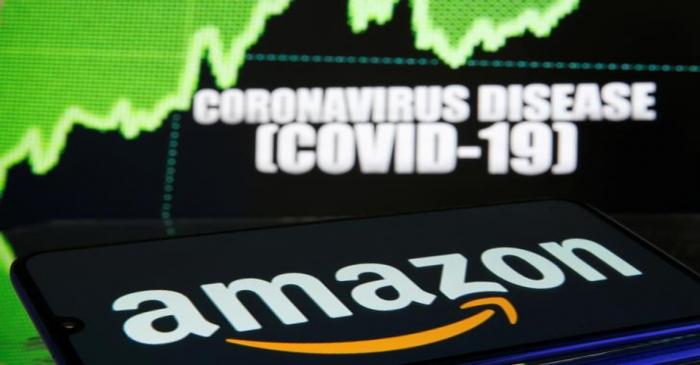 Amazon logo is seen in front of diplayed coronavirus disease (COVID-19)