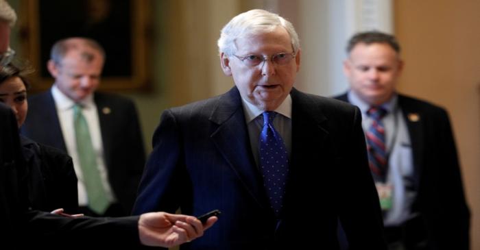 Senate Majority Leader McConnell speaks to members of the news media while walking into his