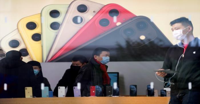 FILE PHOTO: People wearing protective masks are seen in an Apple Store, as China is hit by an