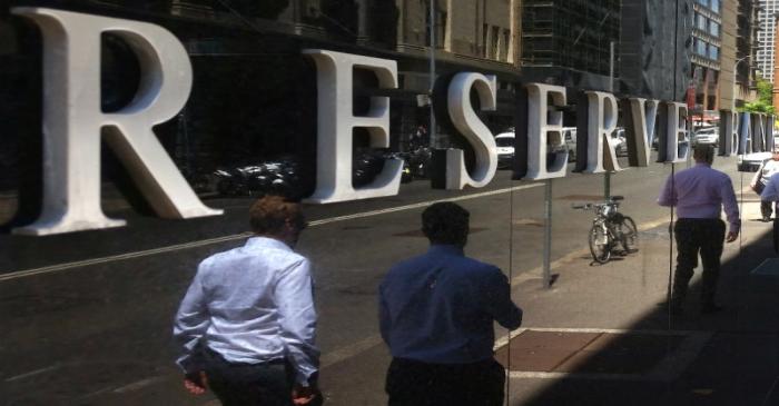 Pedestrians walk past the Reserve Bank of Australia building in central Sydney