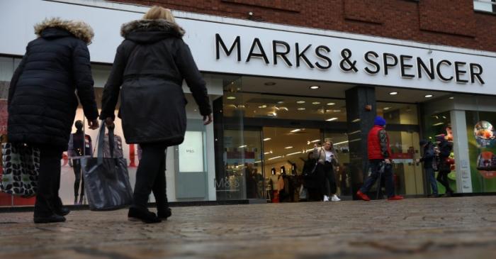 Shoppers walk past a branch of Marks and Spencer in Altrincham, Britain