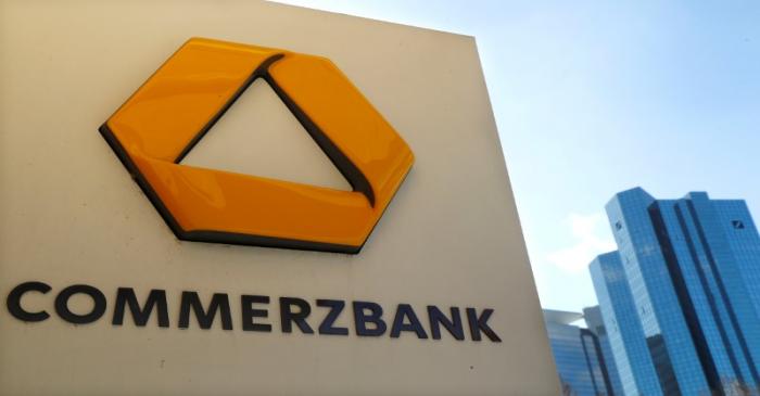 FILE PHOTO: A sign for an ATM of Commerzbank is seen next to the headquarters of Deutsche Bank