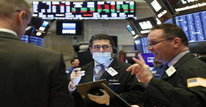 Traders work on the floor of the NYSE in New York