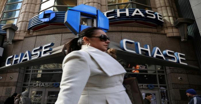 FILE PHOTO: A woman passes by a Chase bank in Times Square in New York