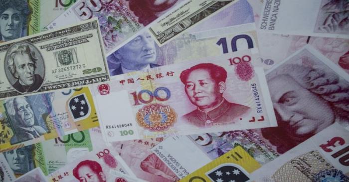 FILE PHOTO:  An advertisement promoting China's renminbi (RMB) or yuan, U.S. dollar and Euro