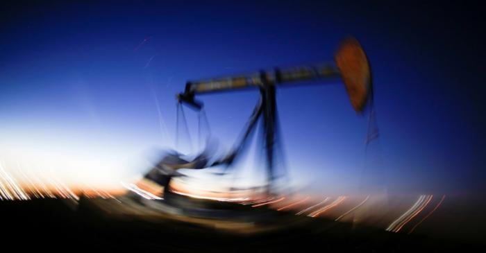 A long exposure image shows the movement of a crude oil pump jack in the Permian Basin in
