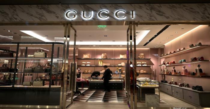 FILE PHOTO: Staff members wearing face masks are seen inside a store of an Italian luxury brand