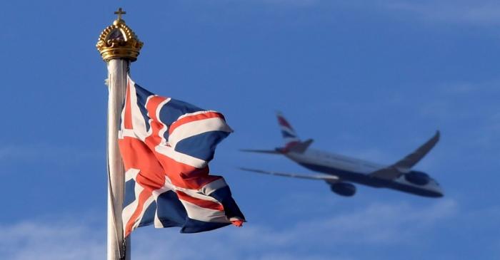 FILE PHOTO: The British Union flag flutters above the Buckingham Palace in London