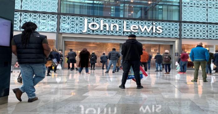 FILE PHOTO: People wait for the John Lewis store to open on Christmas Eve at Westfield